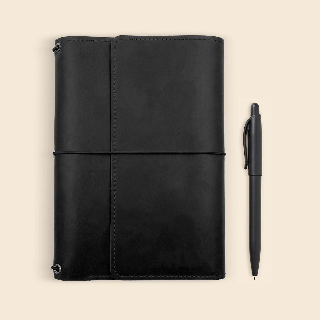 Handcrafted leather notebook case combining classic style with practical storage solutions.