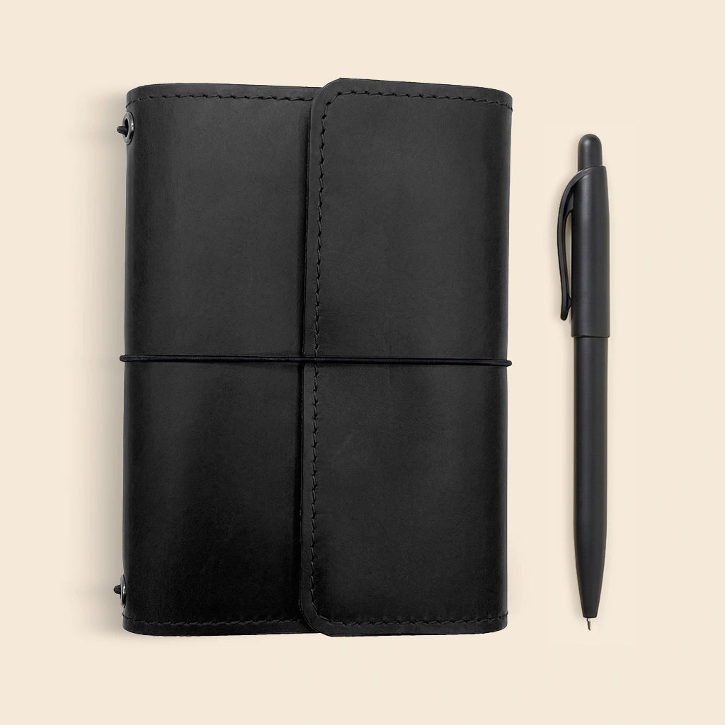 Functional leather notebook cover designed with elastic holders for multiple notebook refills.