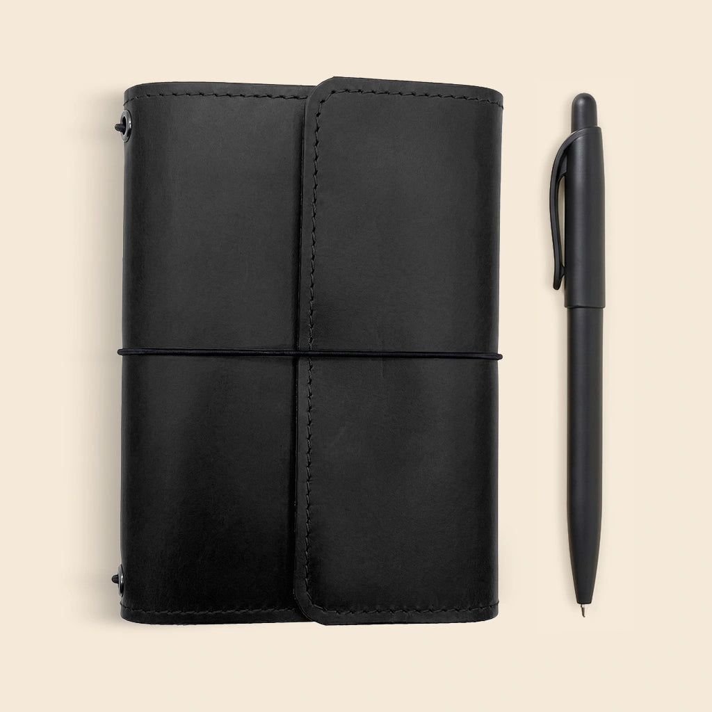 Genuine leather notebook case with elegant design, pen loop, and organizer compartments.