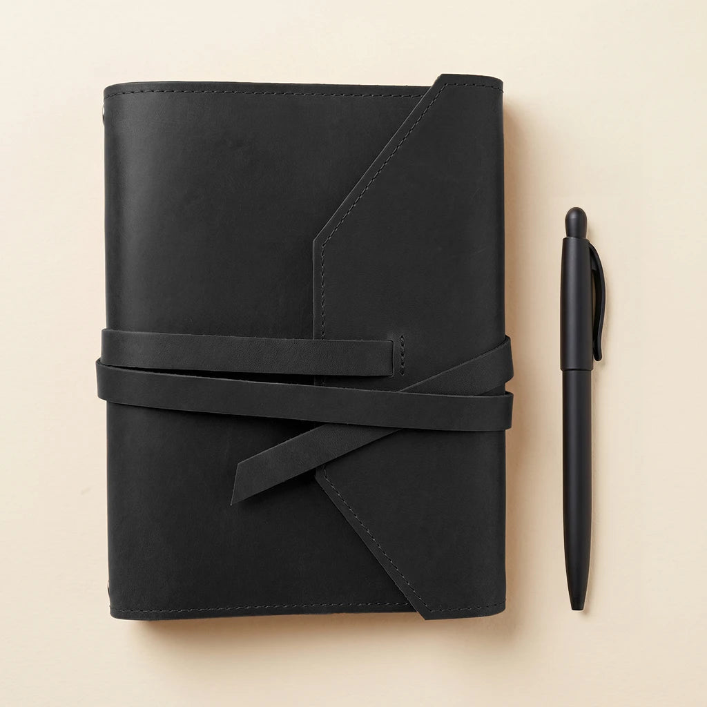 Leather-covered journal case with practical elastics for secure notebook storage.