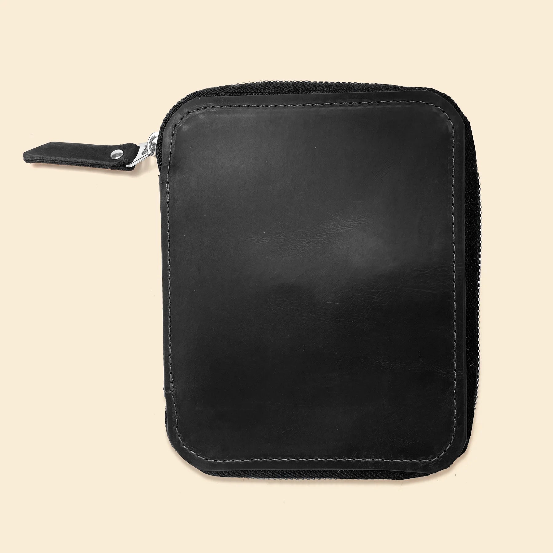 Handcrafted leather pencil organizer featuring zipper closure and compact travel-friendly design.