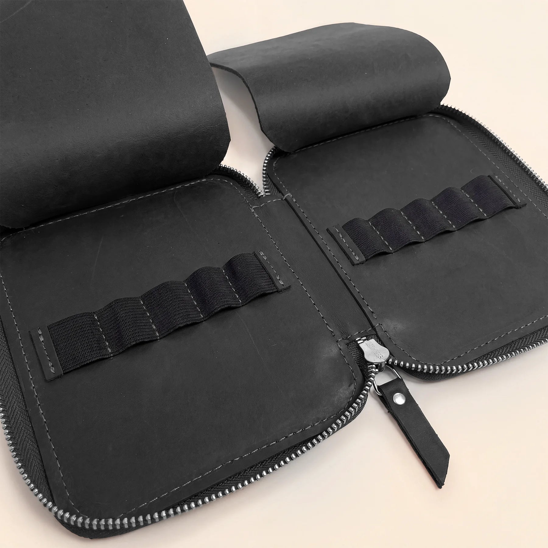 Genuine leather writing tool pouch with secure zipper and premium handmade quality.