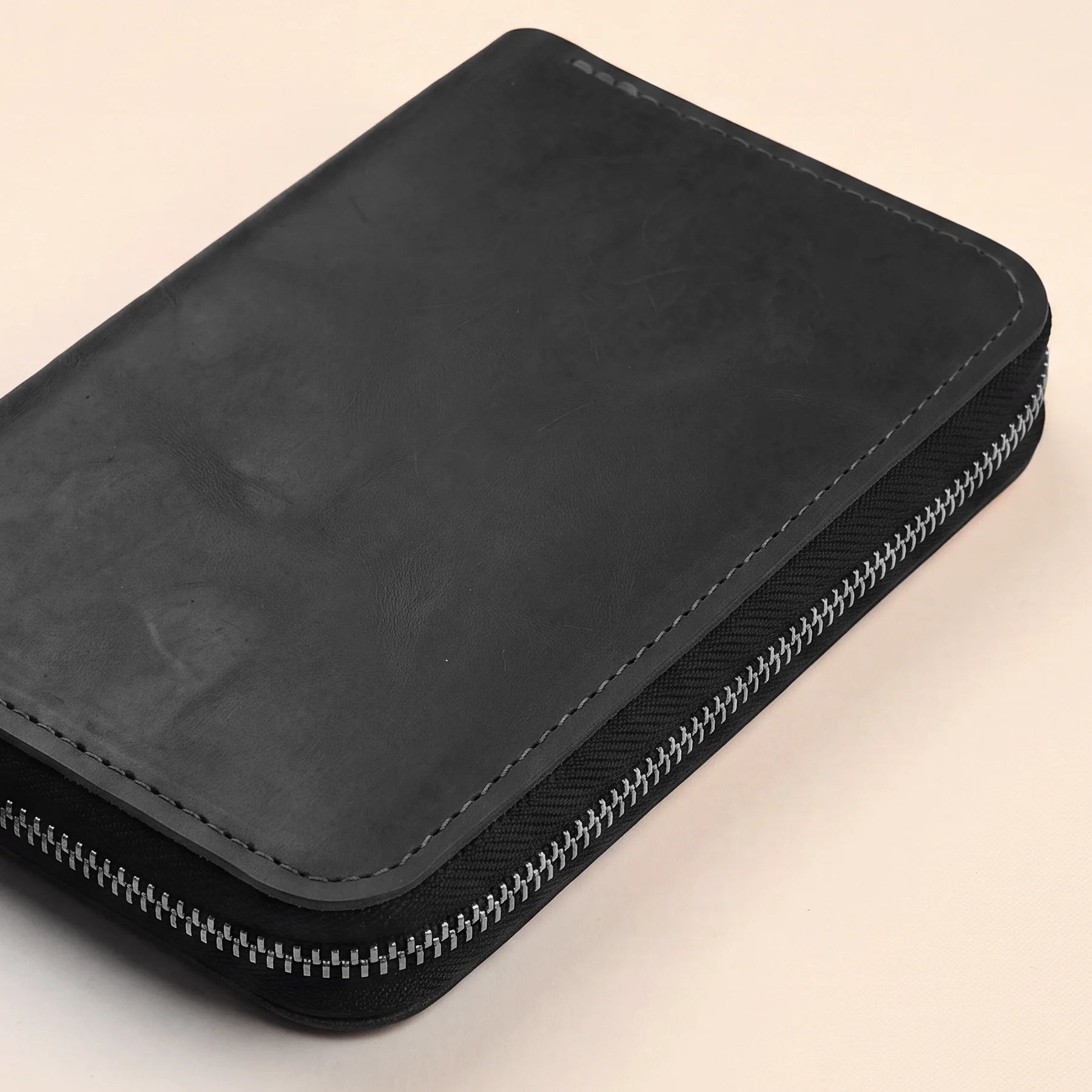 Genuine leather pencil pouch with zipper for stylish everyday stationery organization.