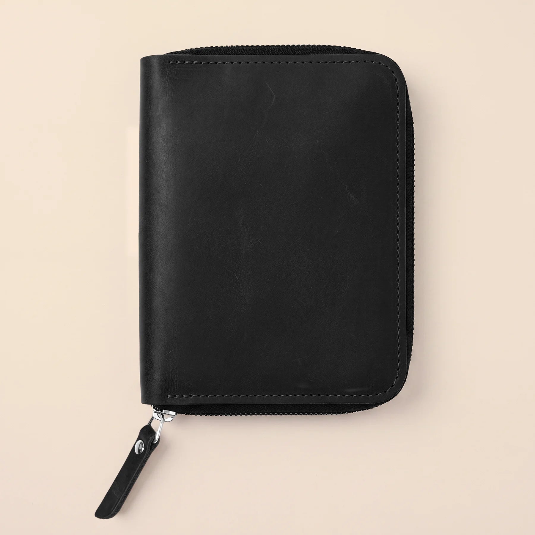 Genuine leather organizer pouch with secure zipper for creative and office supplies.