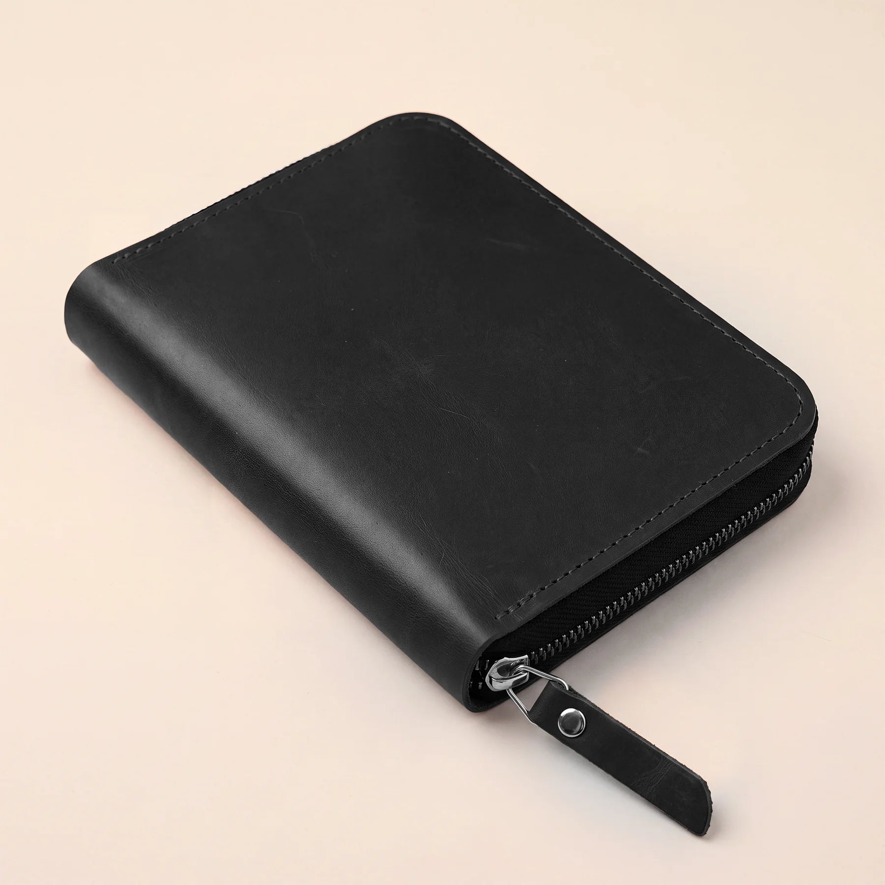 Slim leather stationery wallet with zipper fits everyday writing essentials comfortably.