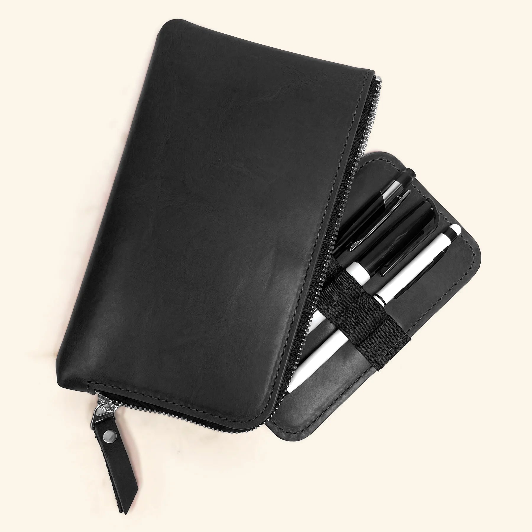 Compact handcrafted leather utility case with zipper for everyday writing supplies.