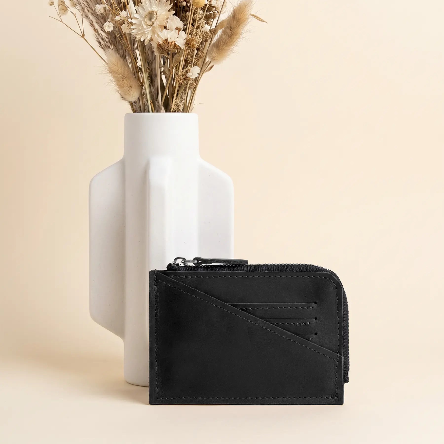 Handmade compact leather wallet with premium zipper closure and elegant minimalist everyday carry design.