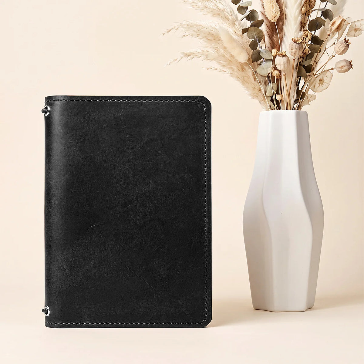 Handmade leather journal cover with secure elastic bands and convenient inner pockets