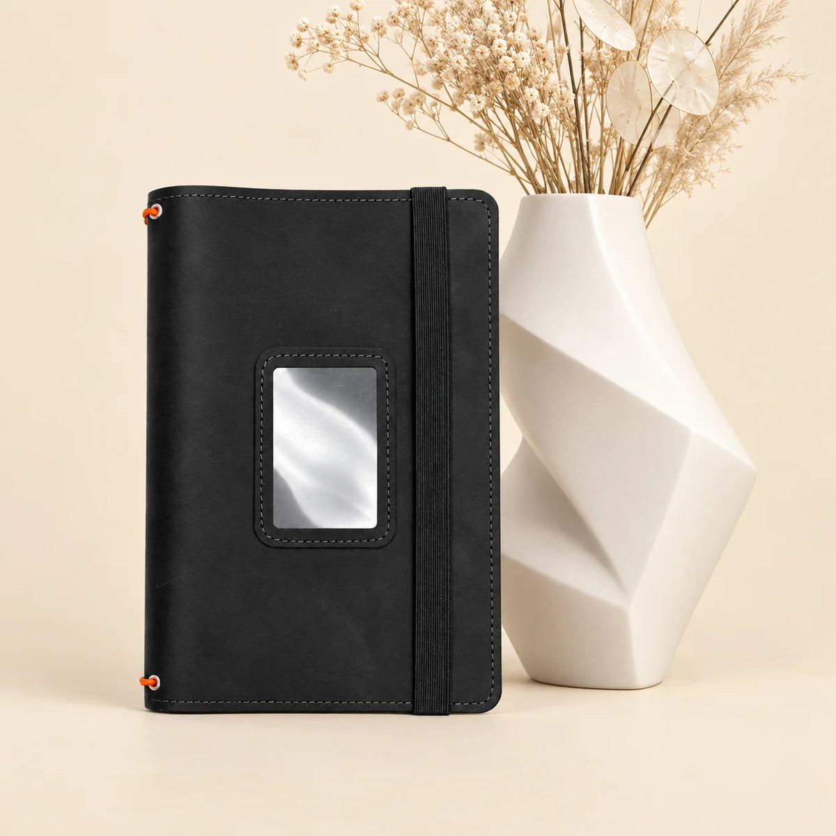 Natural leather notebook organizer featuring three secure holders and several built-in storage pockets.
