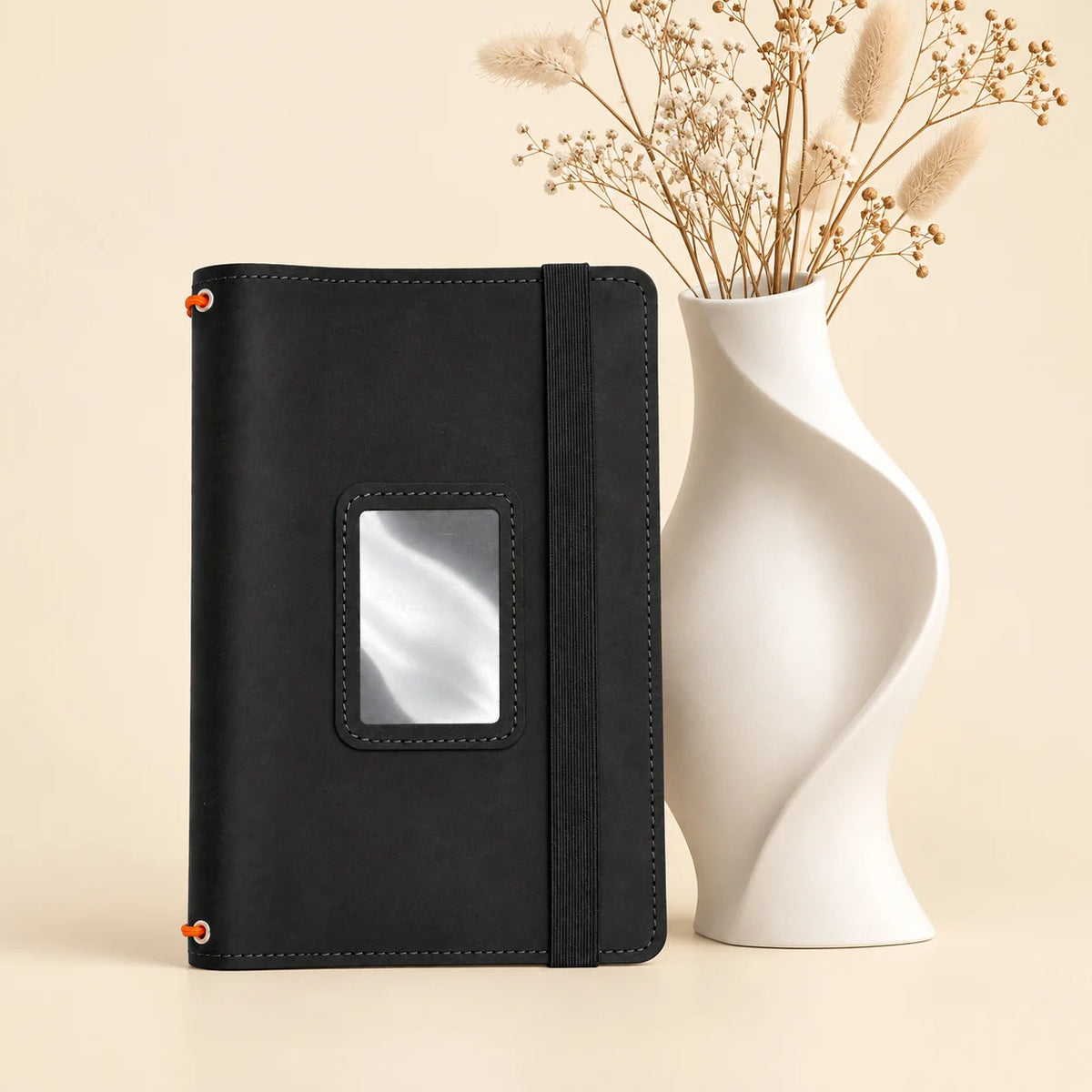 Natural leather journal holder featuring three notebook bands and carefully arranged interior pockets.