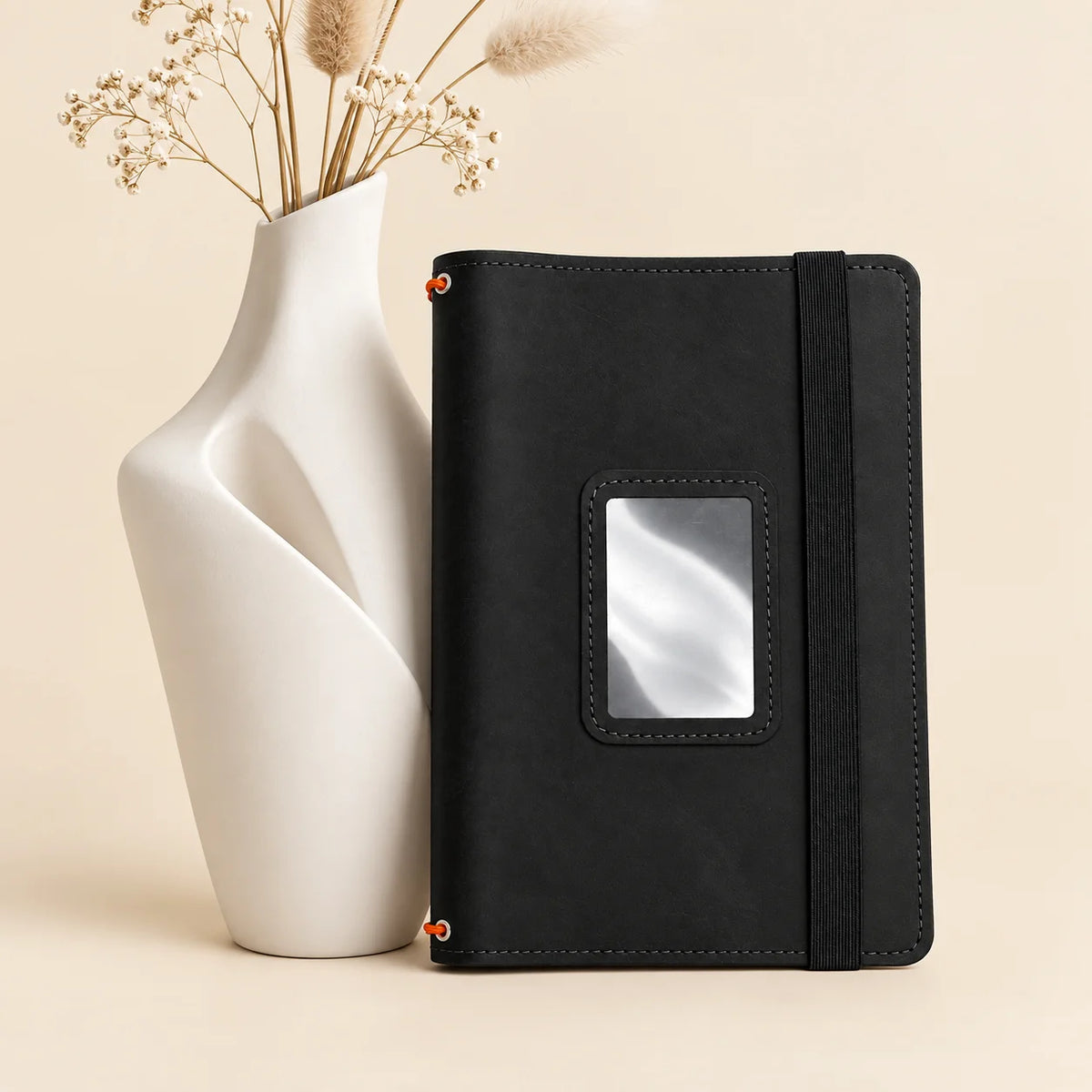 Handmade leather journal cover with three elastic bands and practical storage compartments.