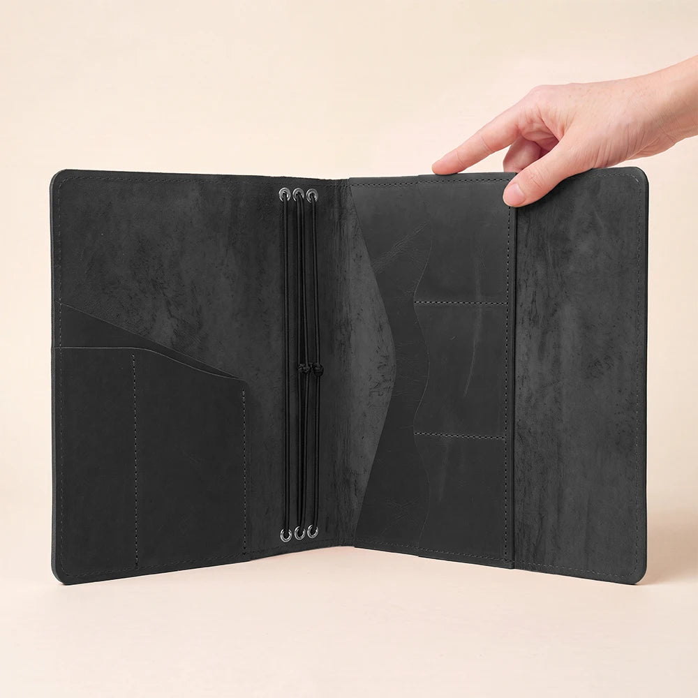 Leather notebook case featuring organized interior layout and flexible refillable notebook insert system.