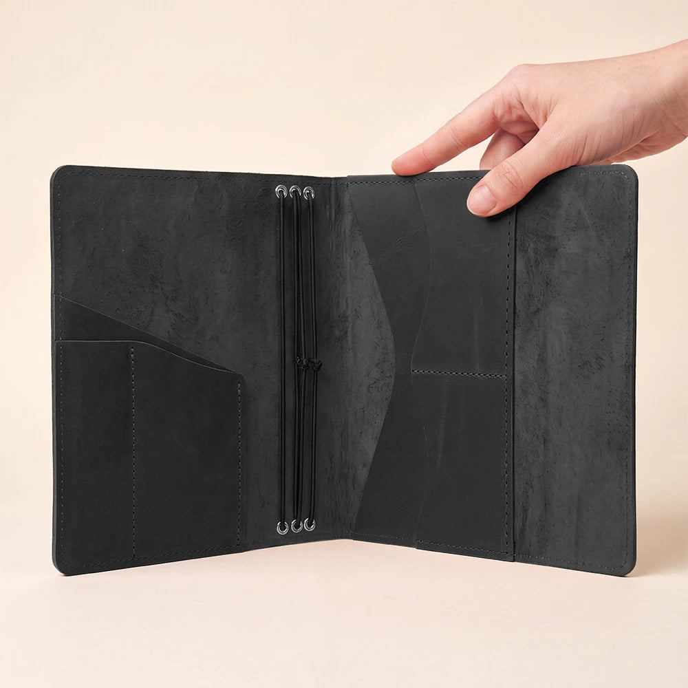 Handmade leather notebook cover with interior organization pockets and refillable elastic insert system.