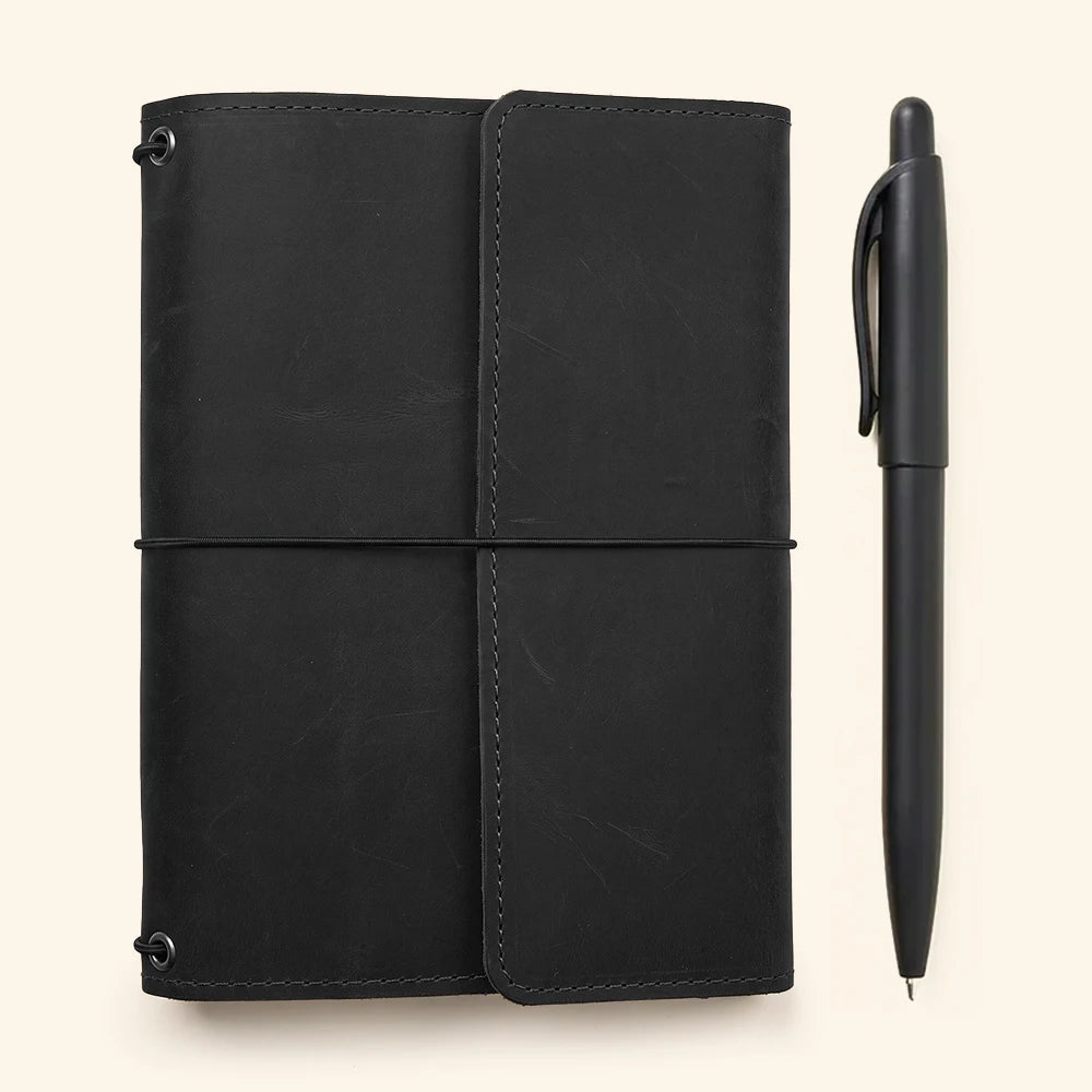 Genuine leather refillable journal cover with organized interior compartments and elastic notebook holders.