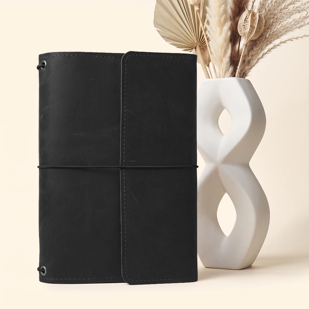 Premium leather journal holder with practical interior pockets and secure notebook elastic loops.