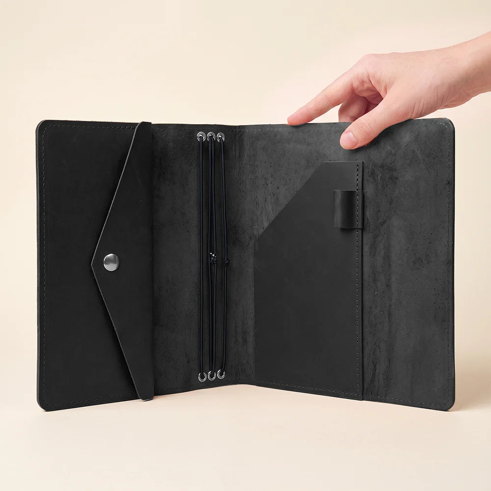 Leather journal organizer featuring timeless craftsmanship, practical storage, and refillable notebook functionality.