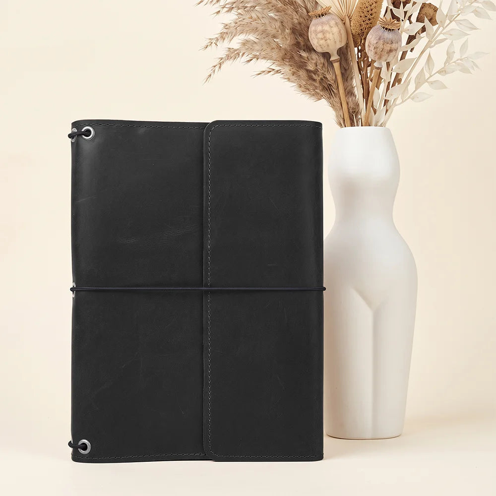 Refillable journal cover in genuine leather for organized notes, sketches, and travel memories.