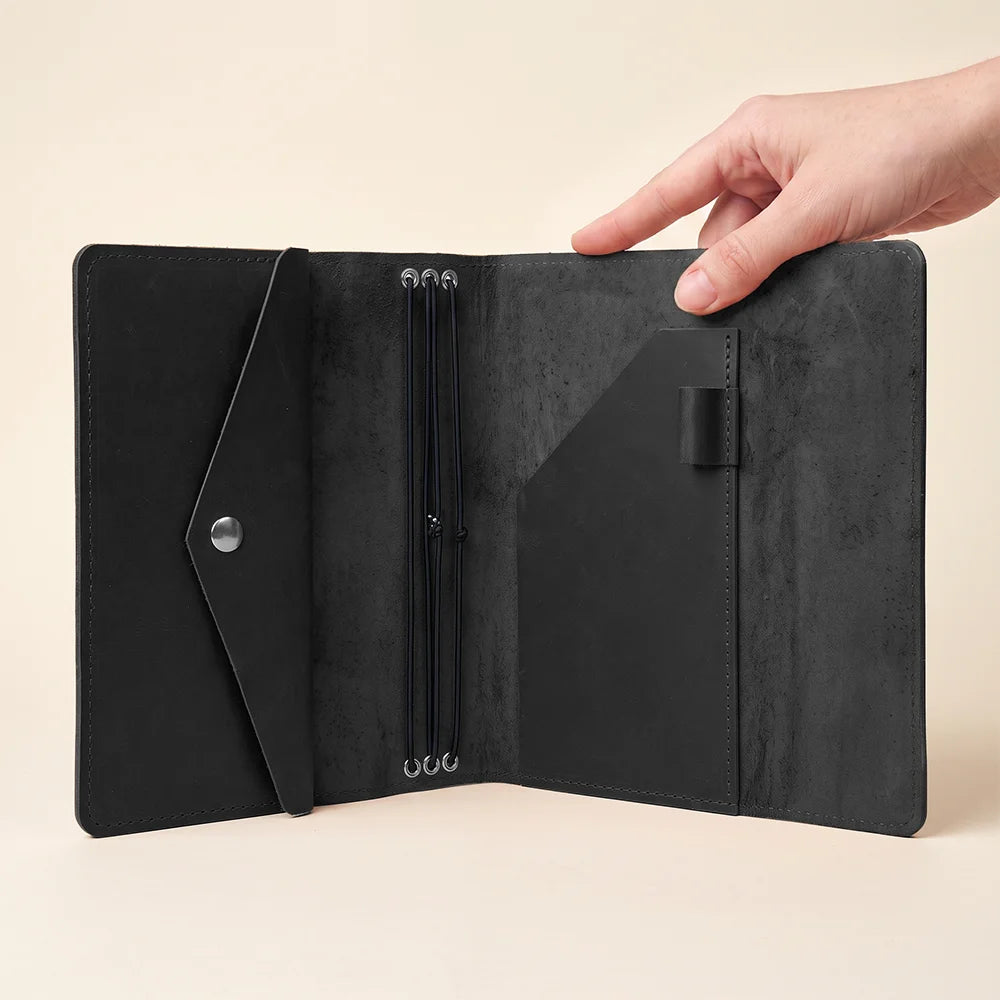Classic leather journal cover with three elastic bands and practical interior organizer compartments.