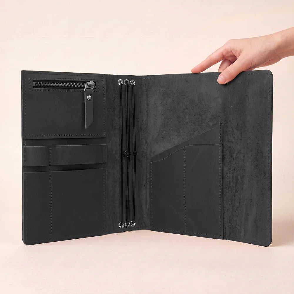Natural leather journal organizer with spacious storage sections and a dedicated holder for pens.