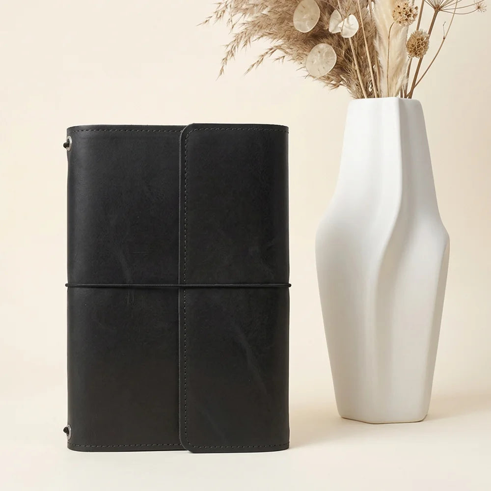 Natural leather journal cover with carefully arranged pockets and an integrated pen carrying loop.
