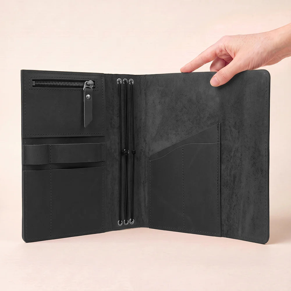 Natural leather notebook organizer with layered compartments and secure storage for essential writing tools.