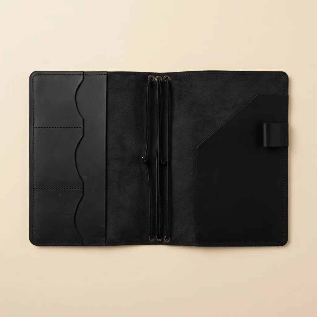 Black leather wallet on a beige background