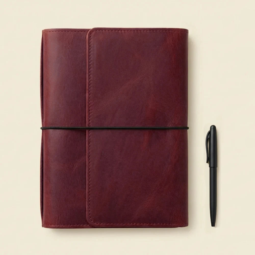 Durable leather notebook organizer featuring refillable elastics and built-in storage pockets inside.