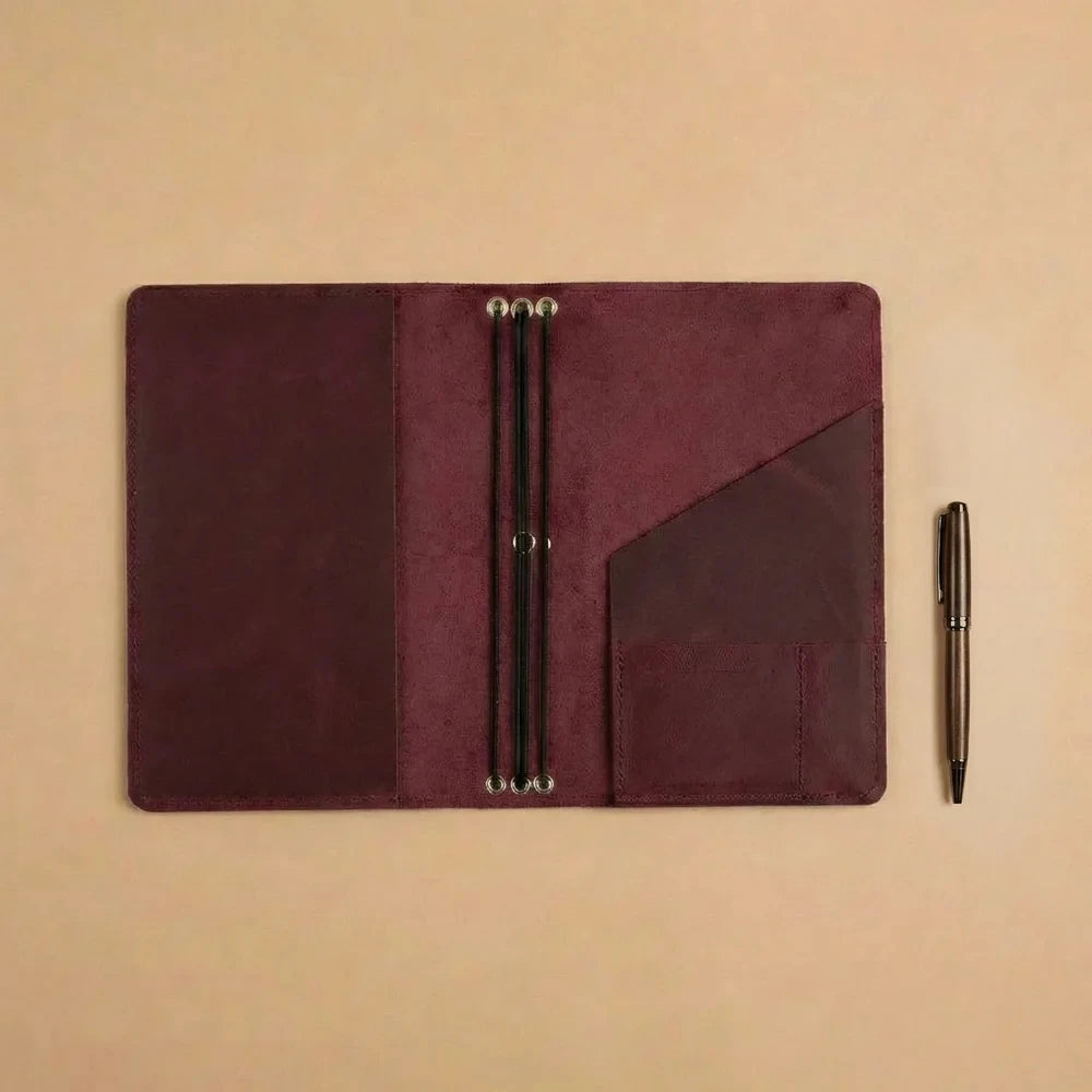 Travel-ready leather notebook cover with refillable journal system and secure interior pockets.