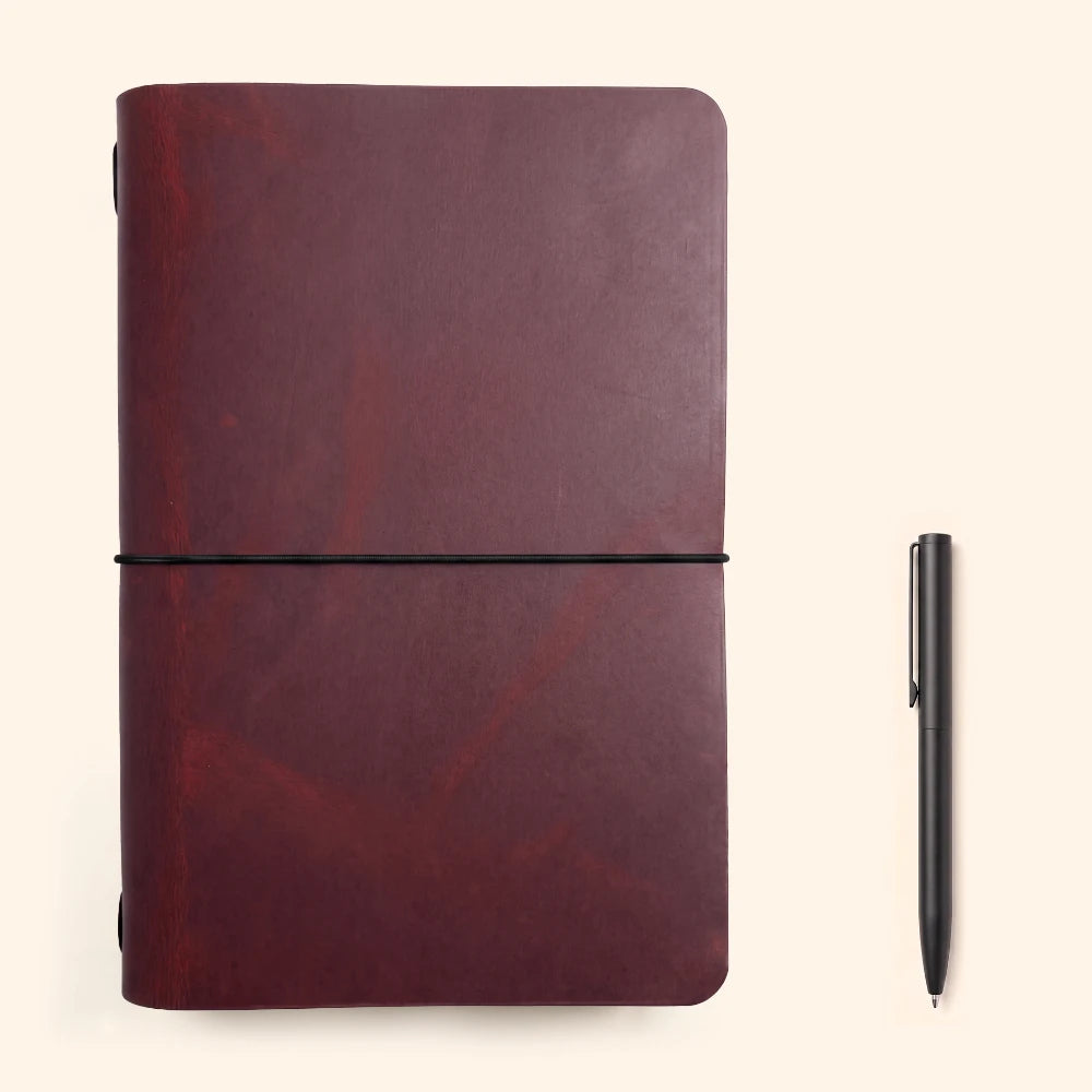 Compact leather notebook wrap featuring a single elastic loop and smooth edges.