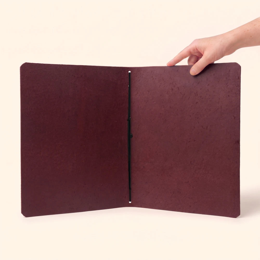 Slim handcrafted notebook sleeve showcasing durable natural leather and practical functionality.