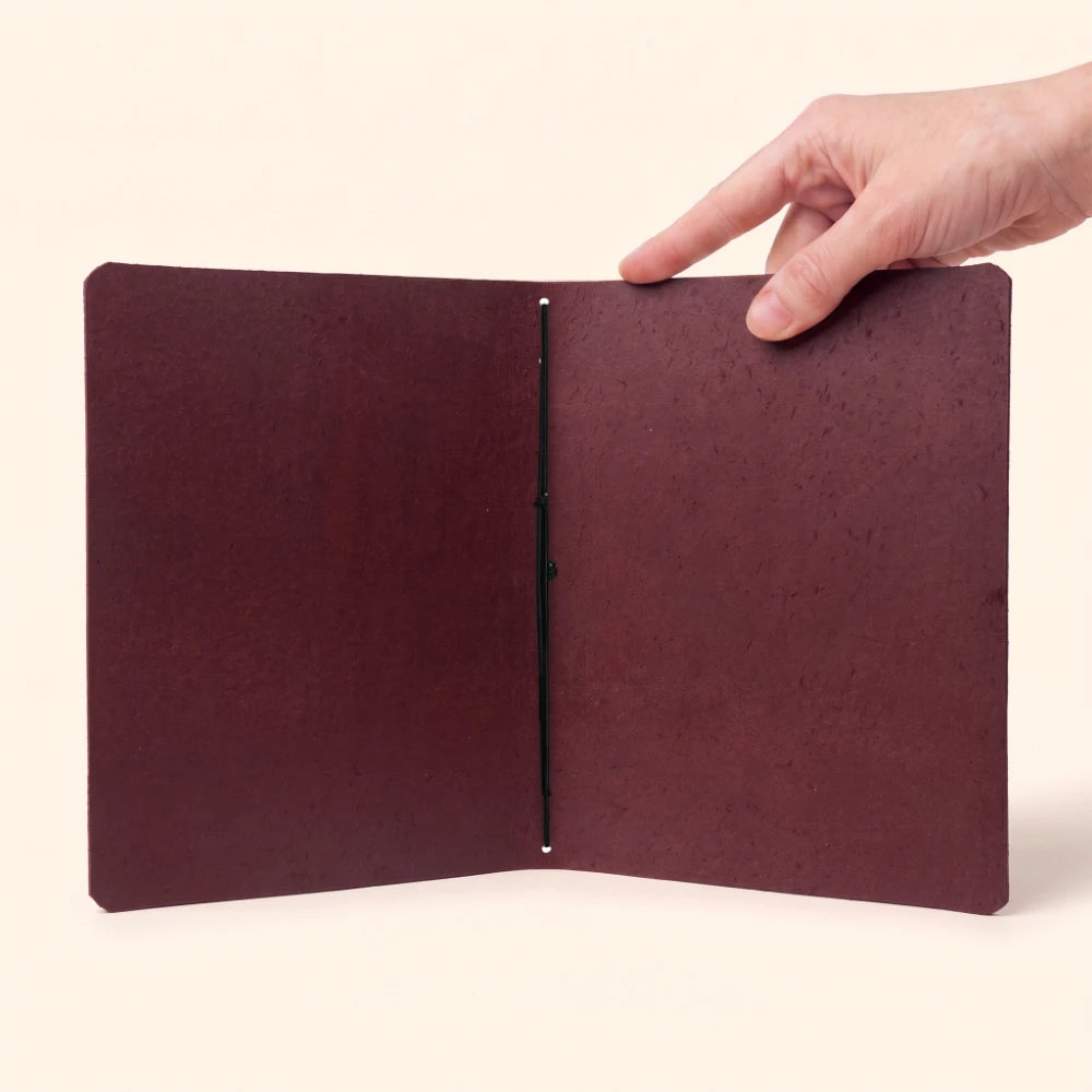 Genuine leather notebook holder with handcrafted details, plain journal, and elastic band.