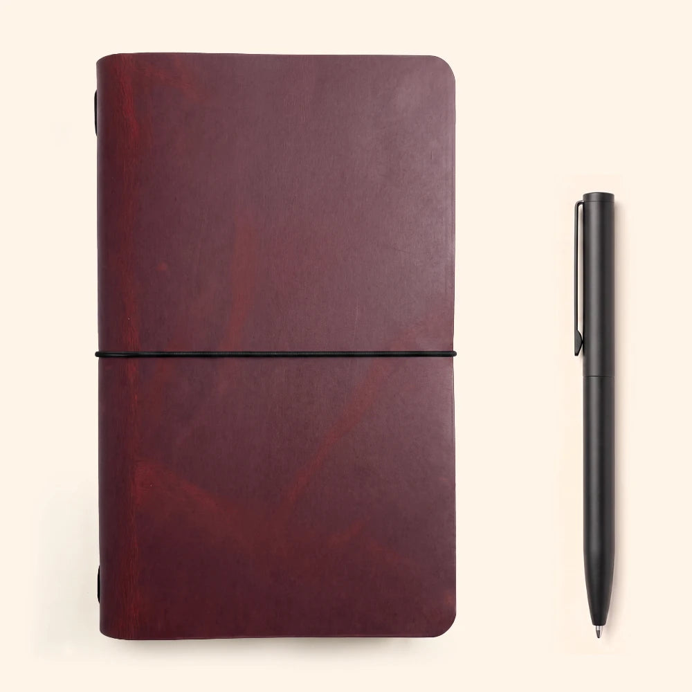 Natural leather cover featuring a plain notebook held securely along its spine.