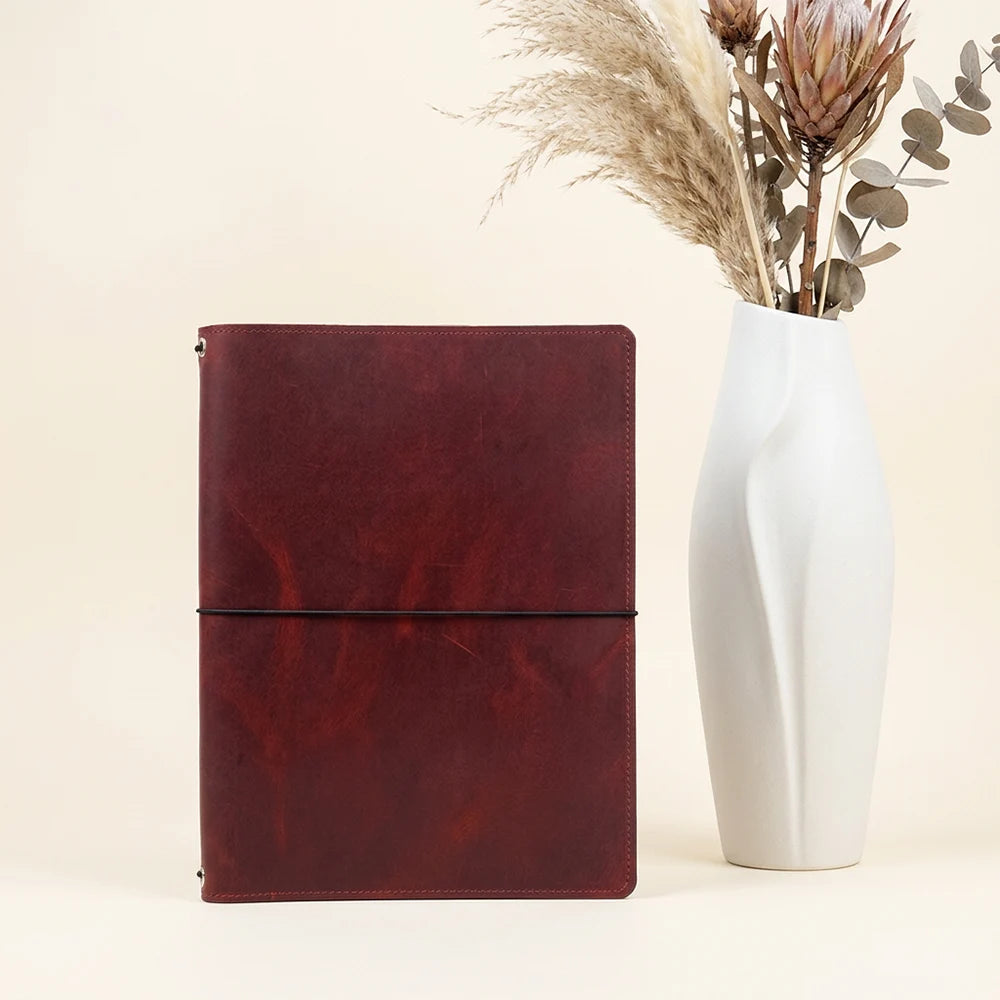 Genuine leather journal holder with interior compartments for notes and sketching materials.
