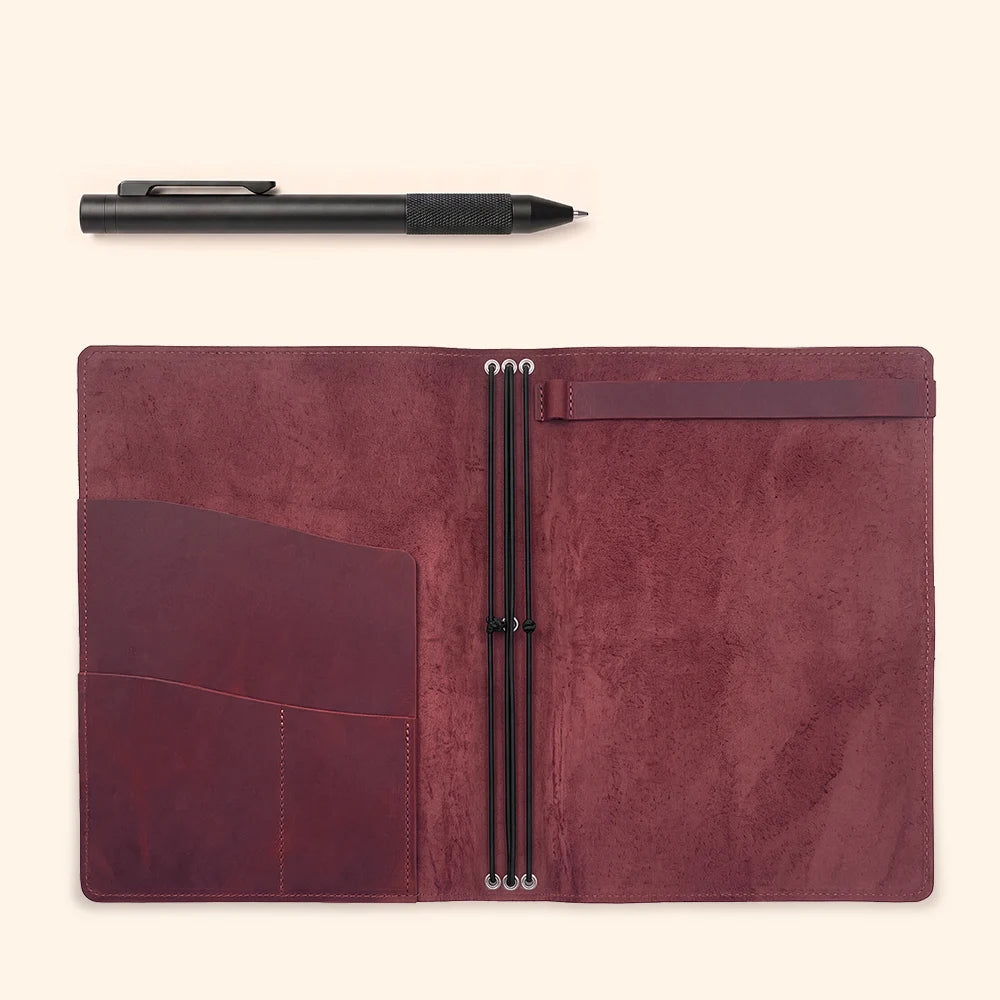 Inside view of a handmade journal cover with pockets and flexible notebook attachment.