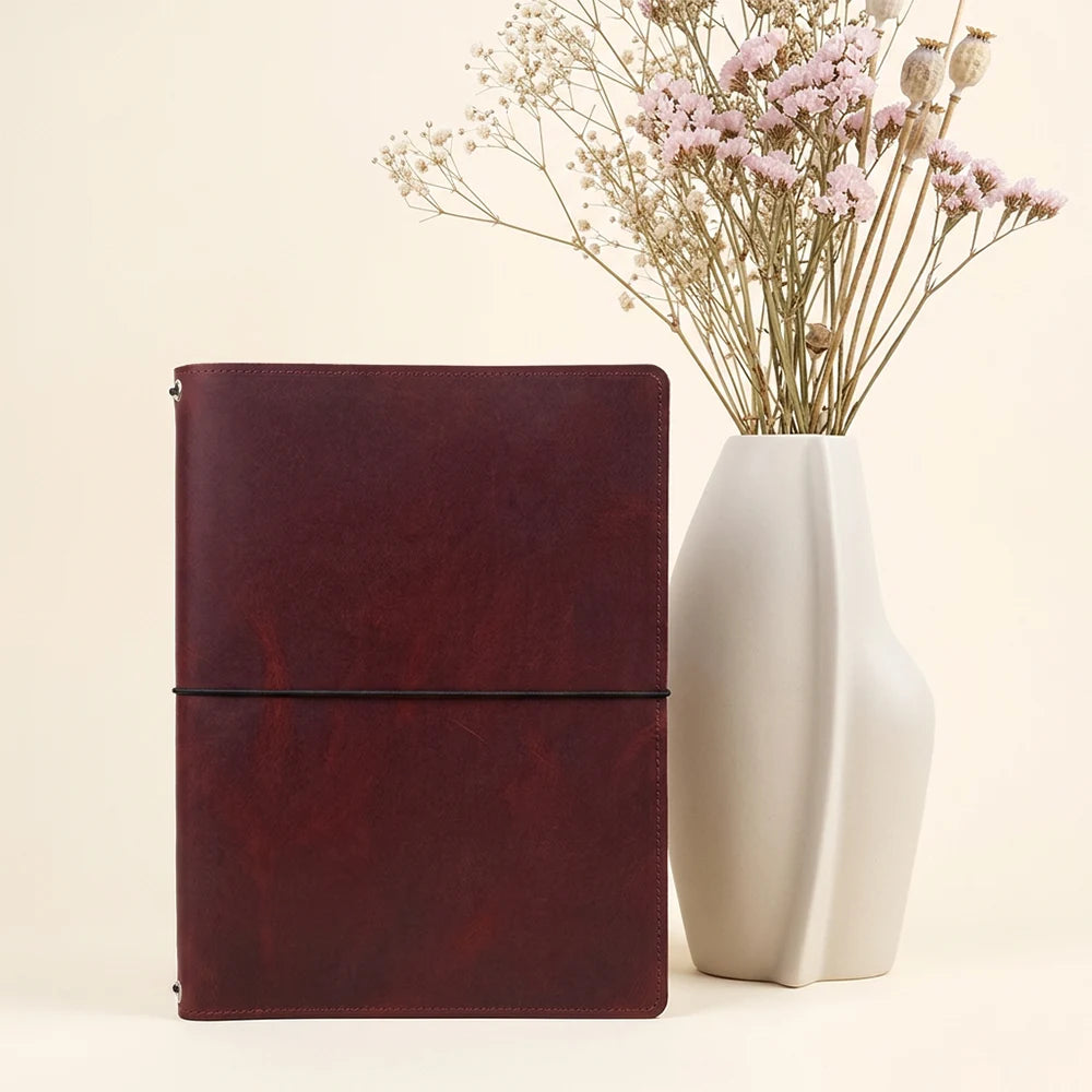 Natural leather notebook holder combining practical storage with flexible insert organization.