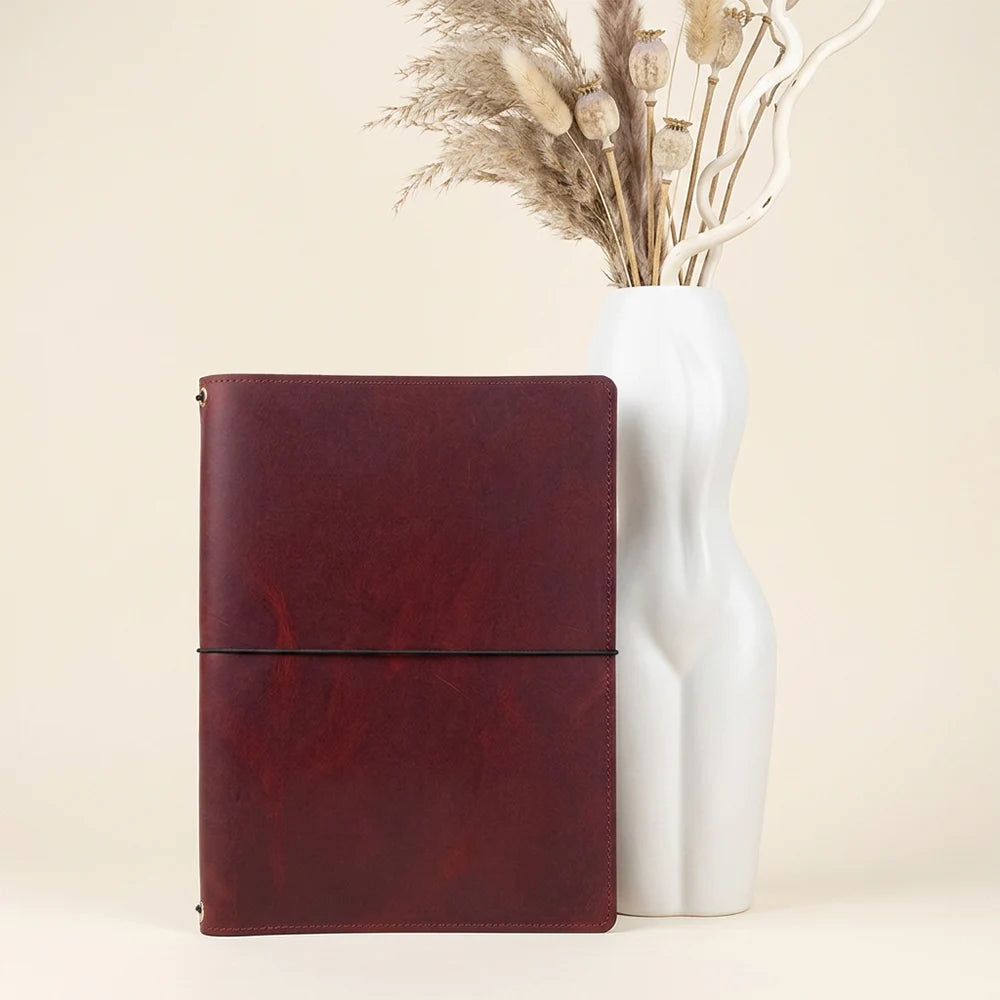 Natural leather notebook organizer with three elastic bands and convenient storage pockets.