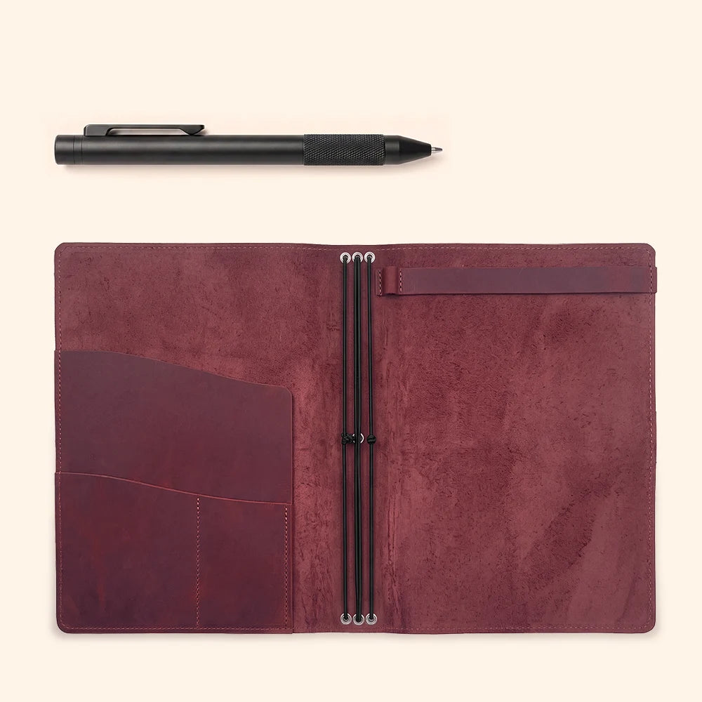 Leather journal case with practical pockets, elastic notebook loops, and sketchbook attachment.