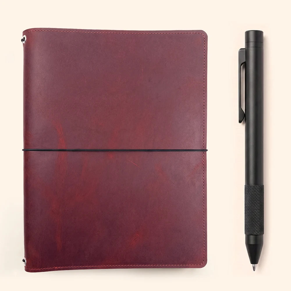 Refillable leather organizer with three elastic bands, interior pockets, and notebook fastening.