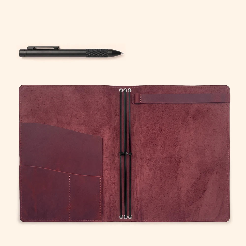 Natural leather notebook holder featuring three internal elastics for flexible insert placement.