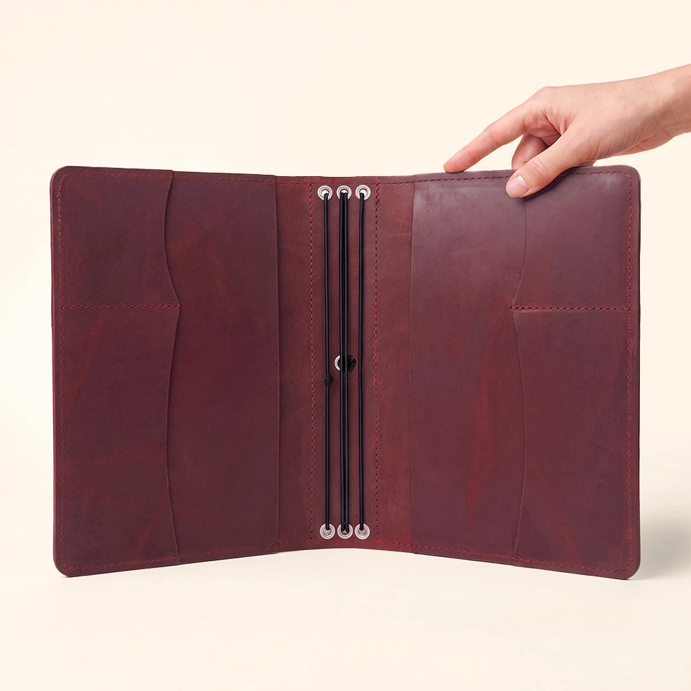 Refillable notebook portfolio with handcrafted leather finish and practical storage compartments.