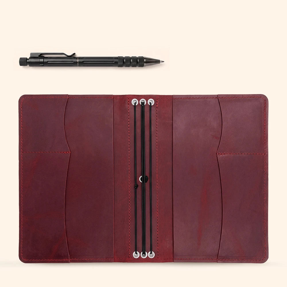 Handmade refillable leather notebook cover with interior compartments and pen holder strap.