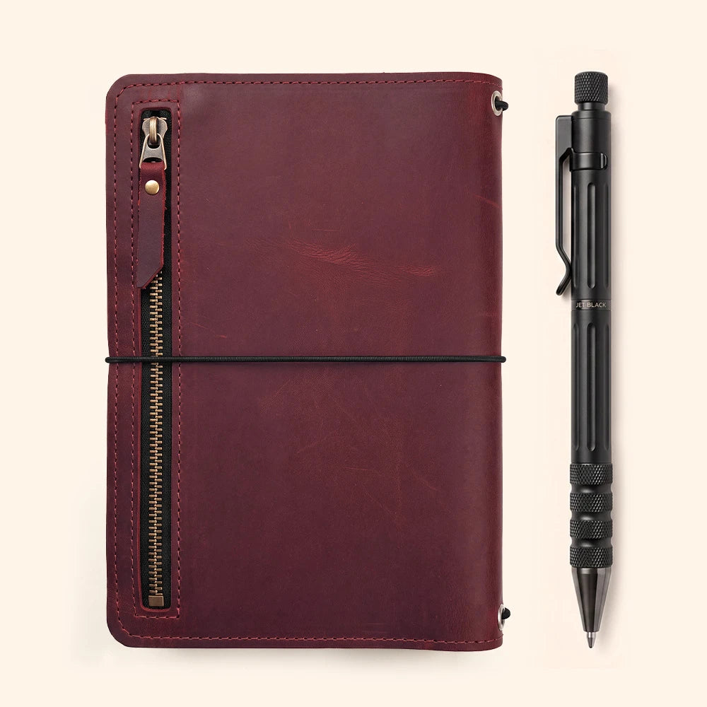 Handmade leather journal cover with practical storage pockets and integrated leather pen loop.