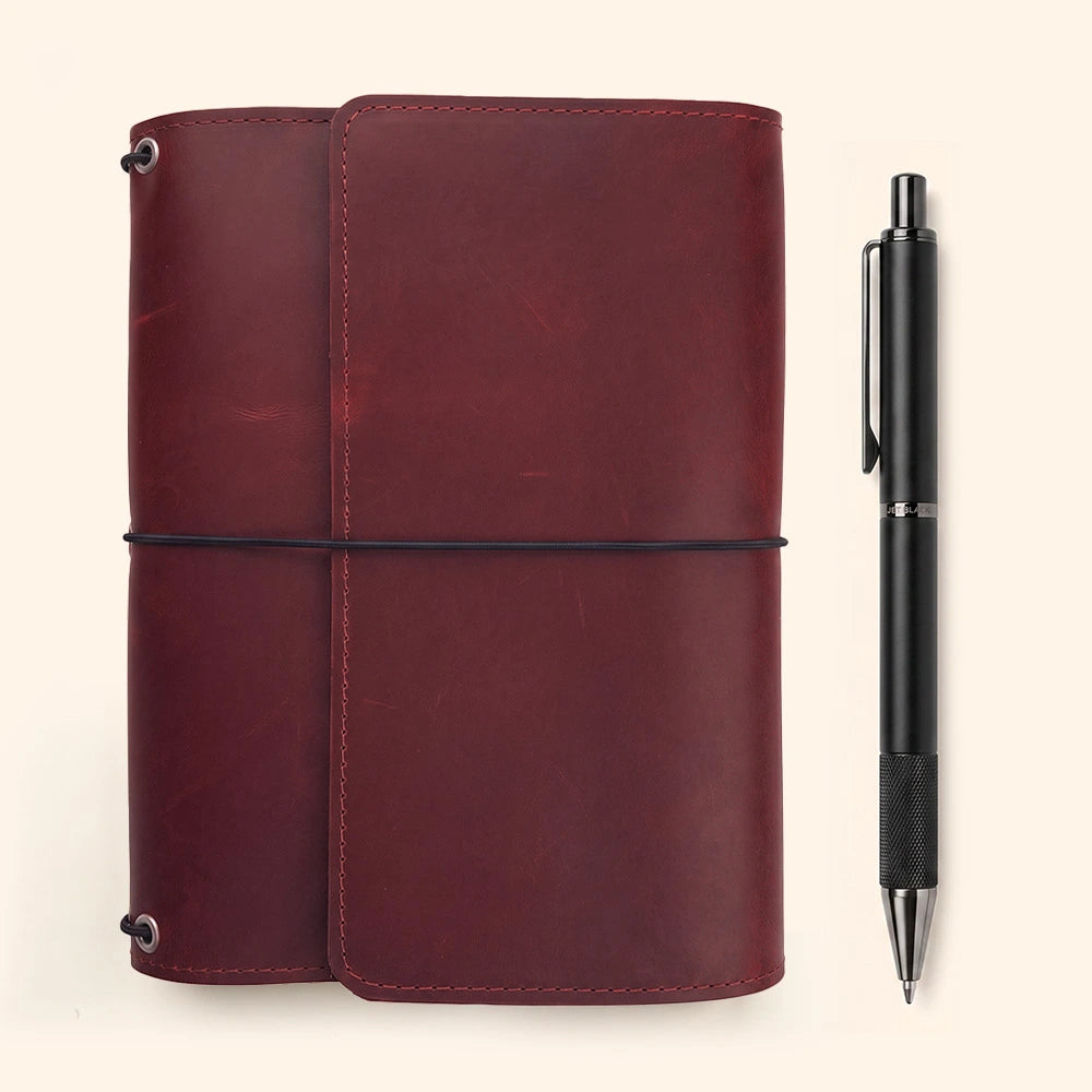 Natural leather notebook sleeve featuring organized interior layout and built-in pen holder.