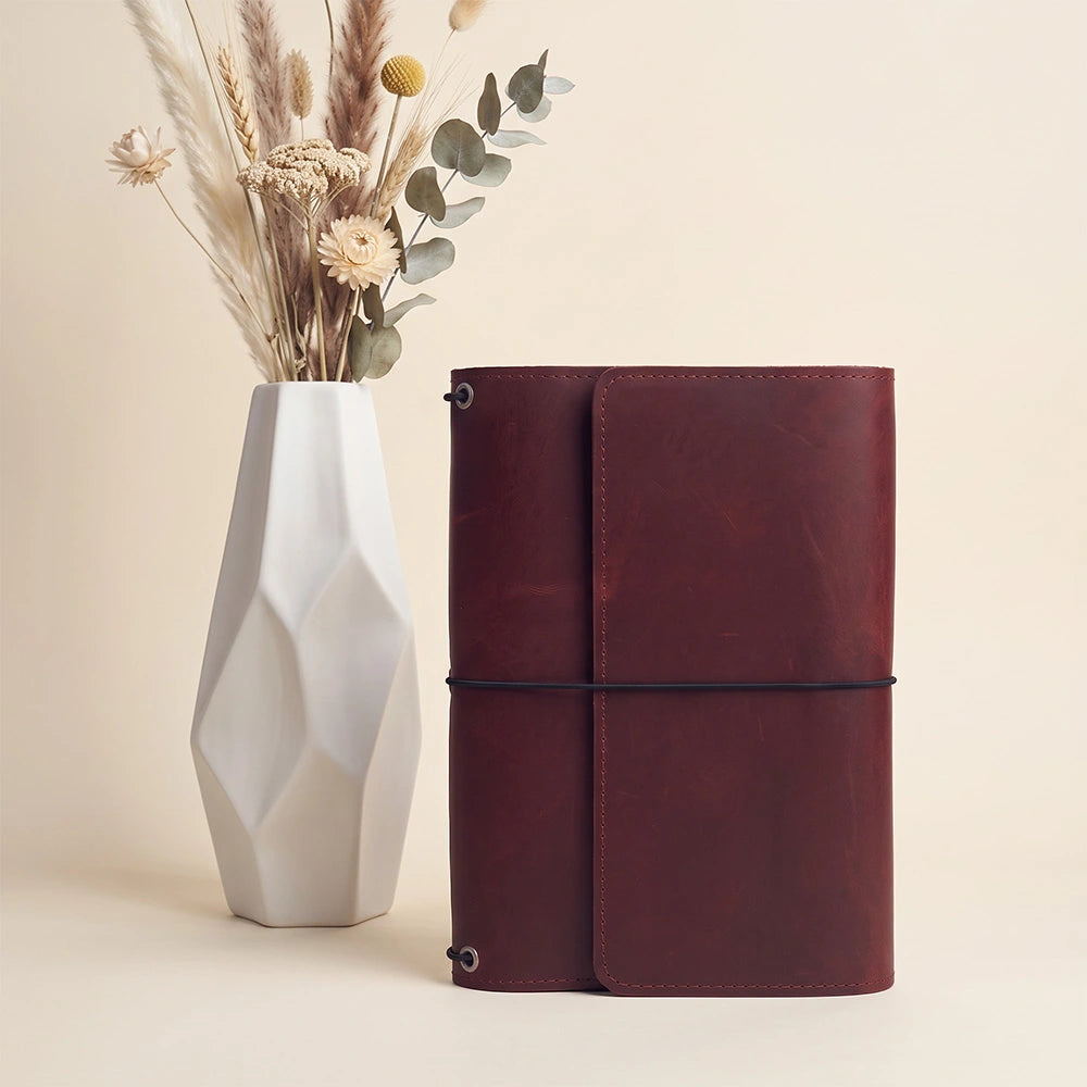 Premium leather diary protector with interior organizer layout and secure pen fastening loop.