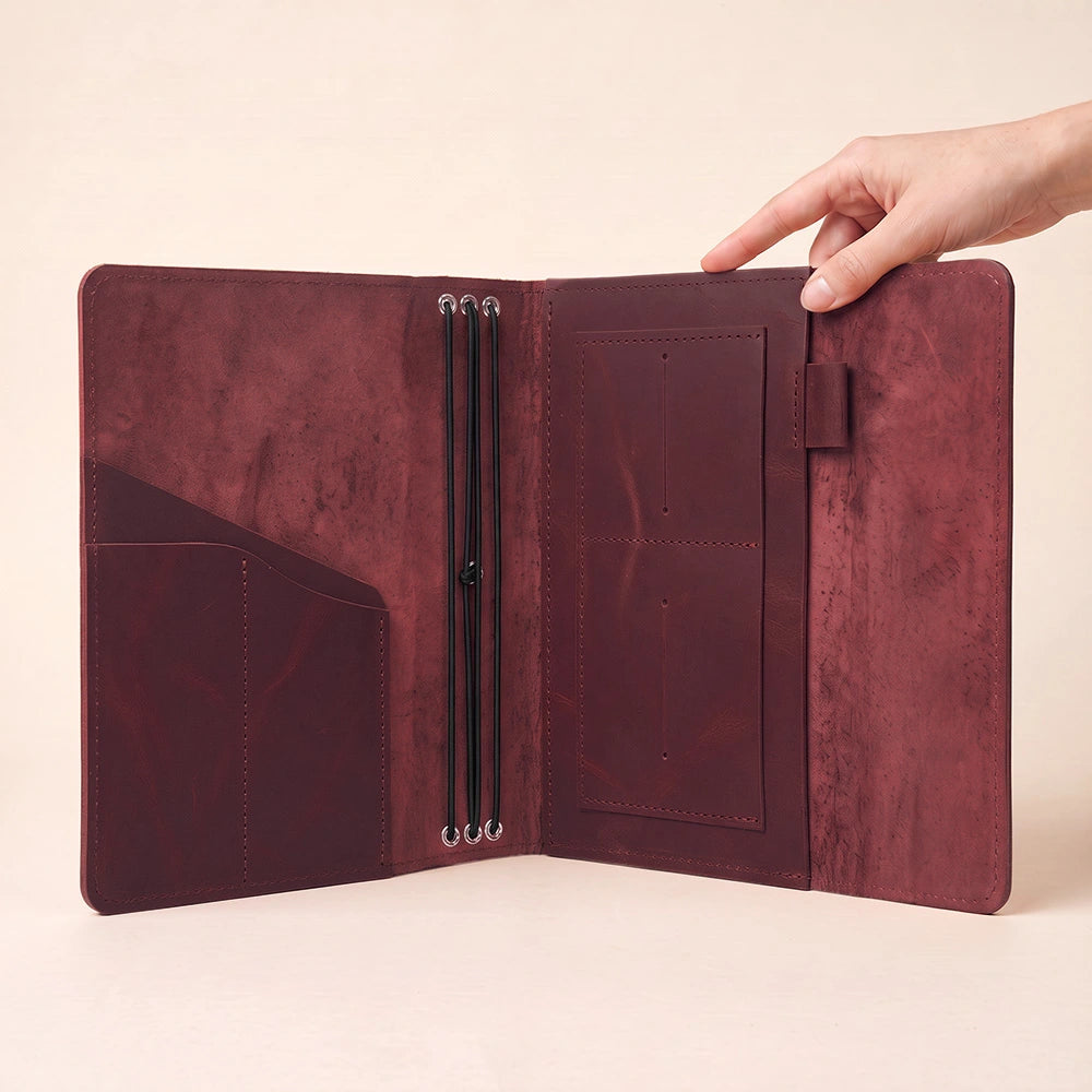 Leather notebook wrap designed for refillable journals with functional pockets and pen keeper.