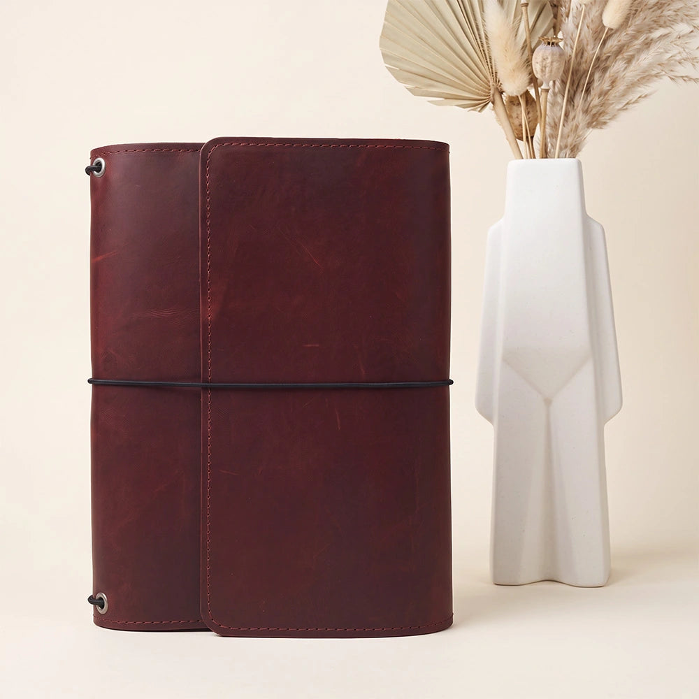 Premium natural leather notebook jacket with organized pockets and leather pen holder included.