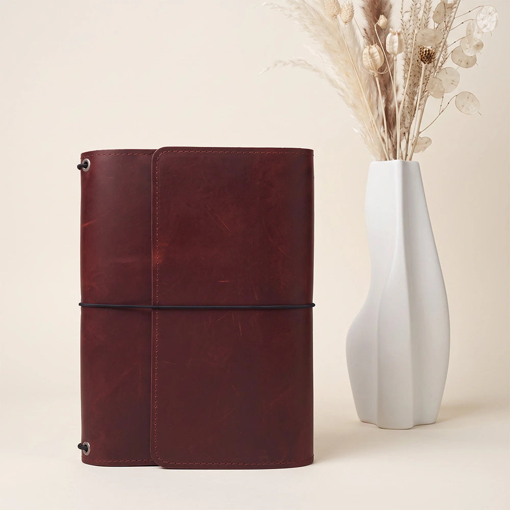 Genuine leather journal cover with organized interior compartments and built-in pen holder.