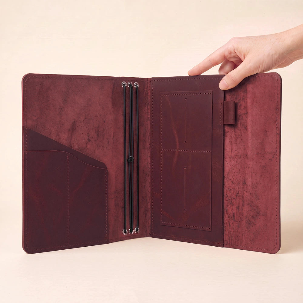Leather writing case with organized inside storage and integrated leather pen keeper.