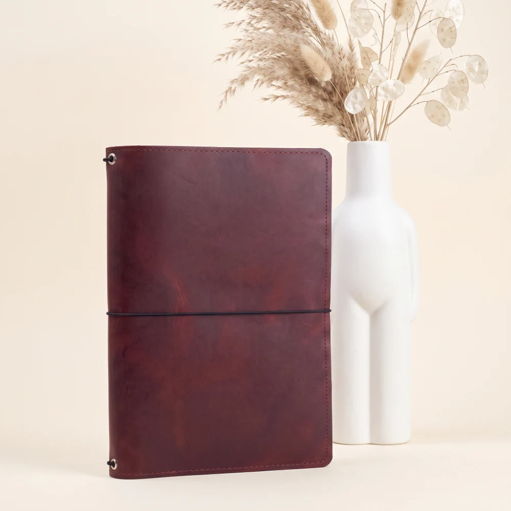 Handmade leather refill system featuring three elastic cords inside the cover.