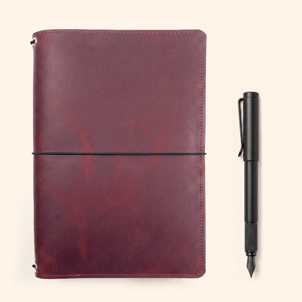 Natural leather journal wrap with triple elastic support for removable notebooks.